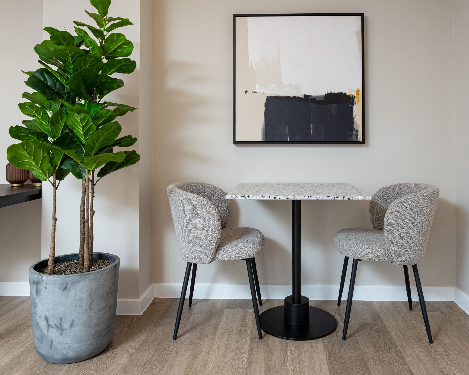 A dining room with a table and chairs and a potted plant at Walton Court.