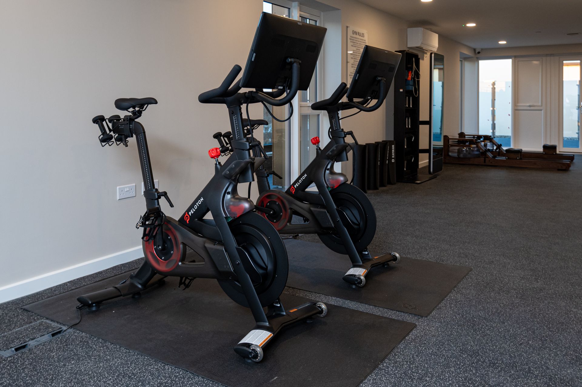 Two exercise bikes are sitting next to each other in a gym at Walton Court.