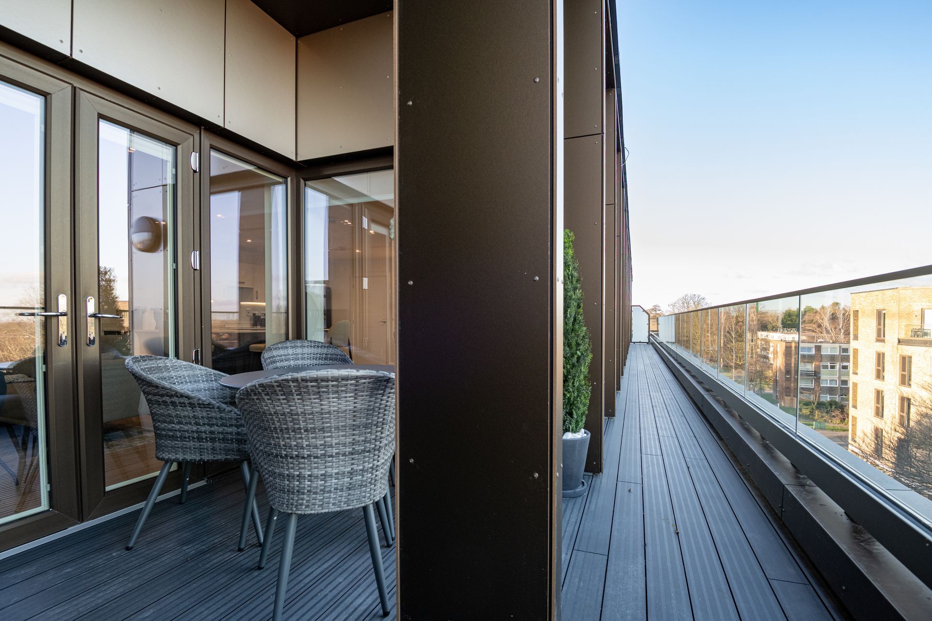 A balcony with a table and chairs on it at Walton Court.