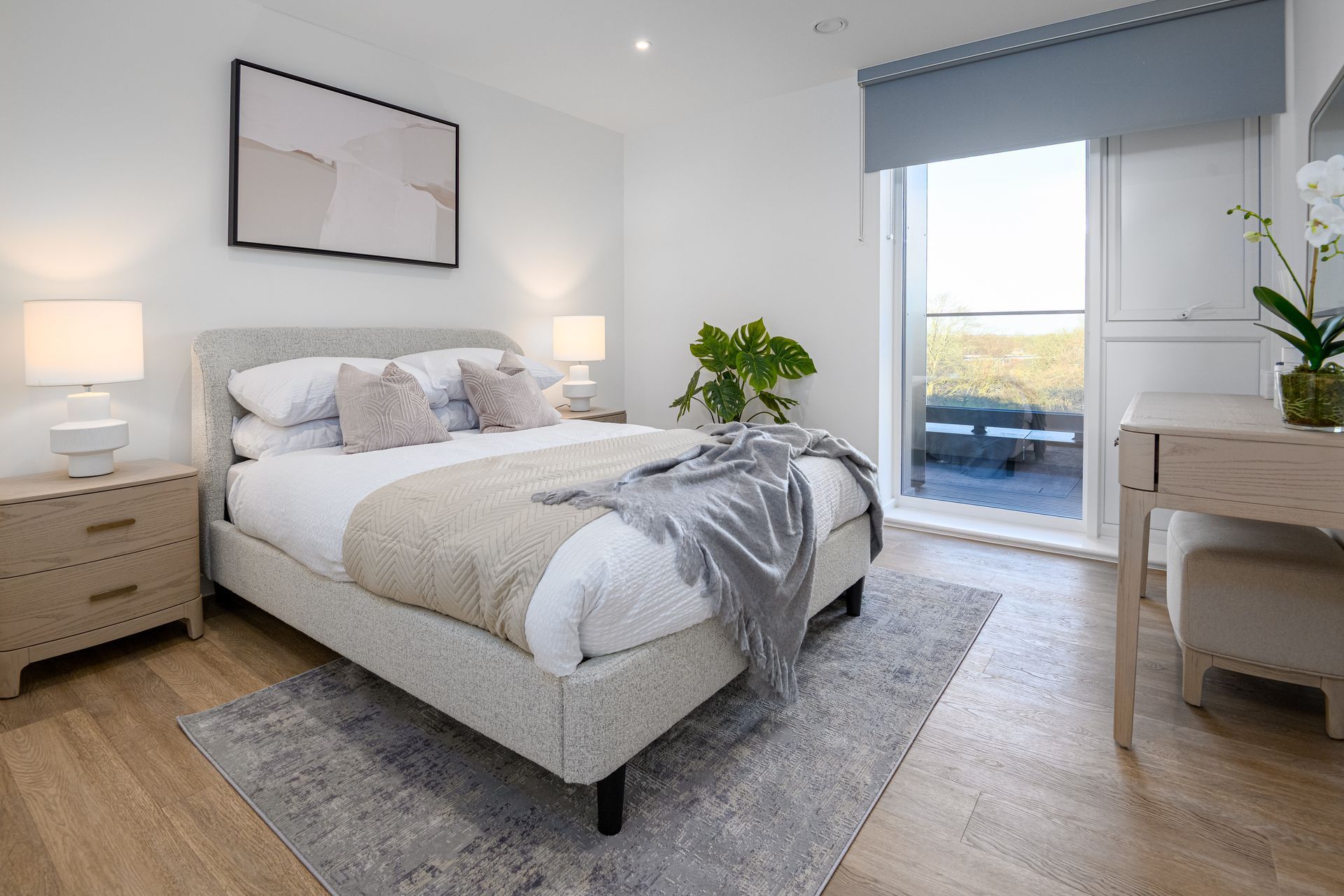 A bedroom with a large bed , nightstands , lamps and a balcony at Walton Court.