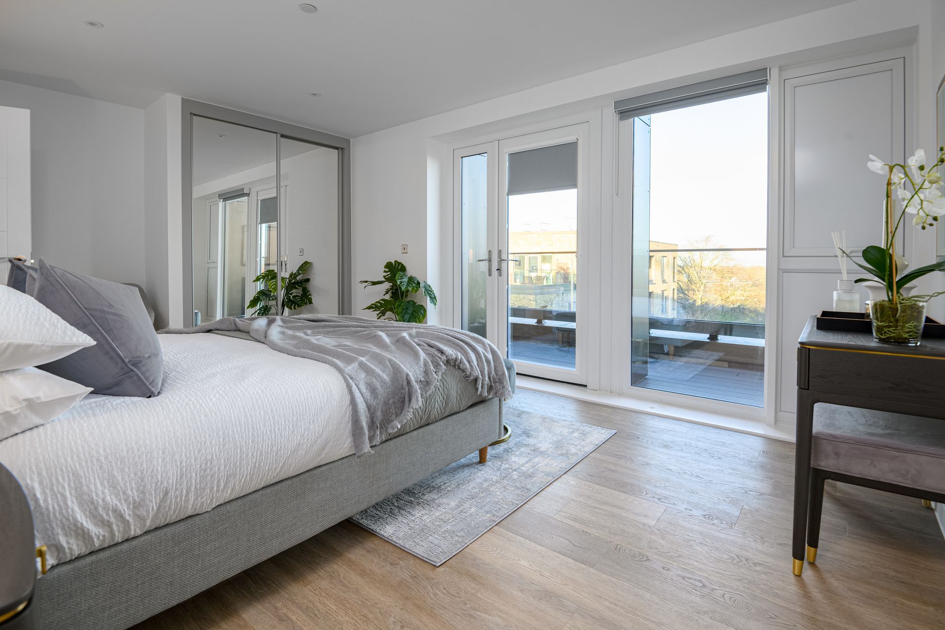 A bedroom with a large bed and a balcony at Walton Court.