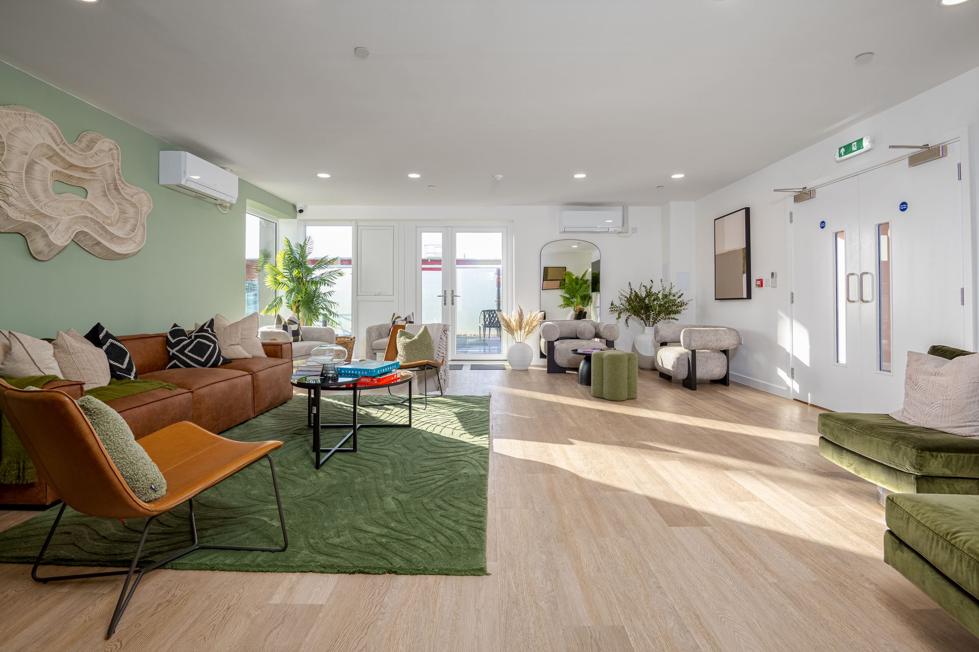 A living room filled with furniture and a green rug at Walton Court.