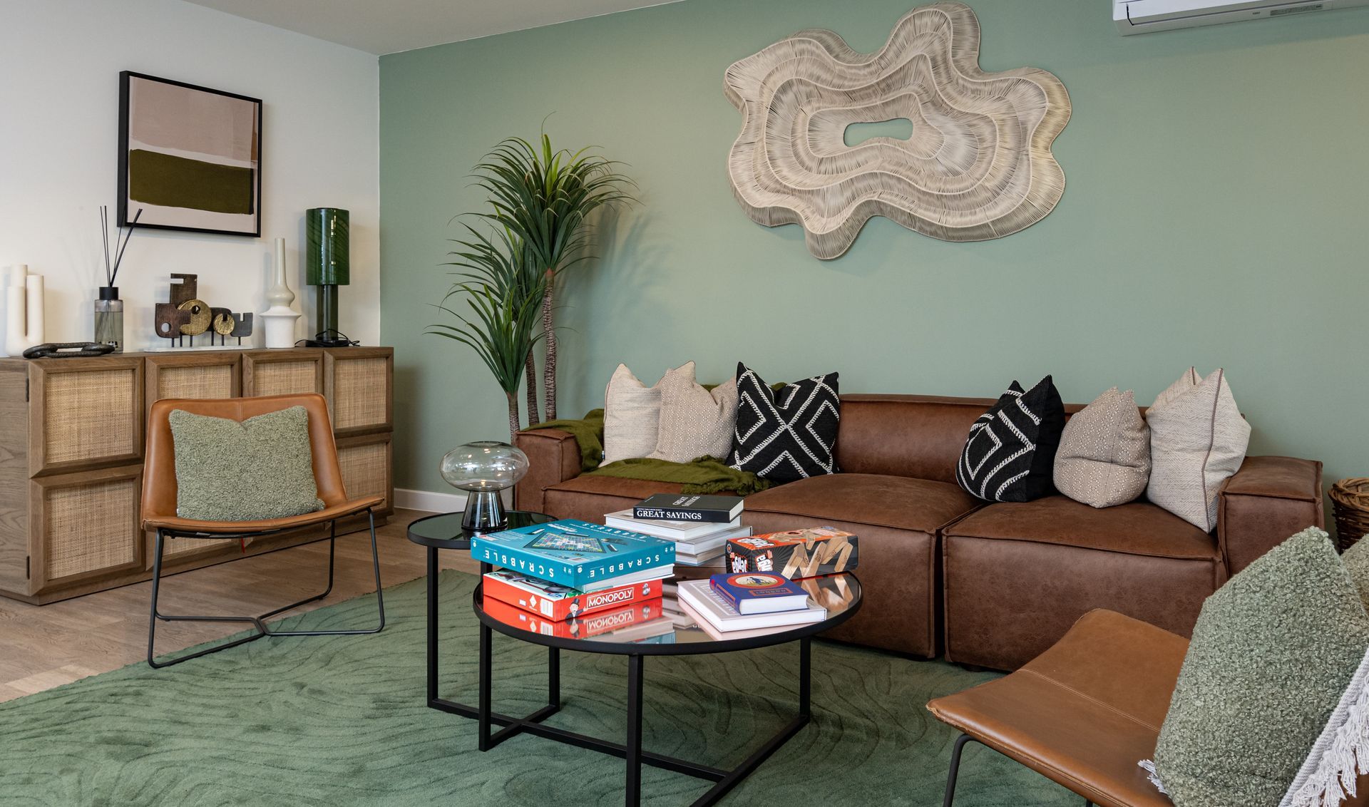 A living room with a brown couch , chairs , and a coffee table at Walton Court.