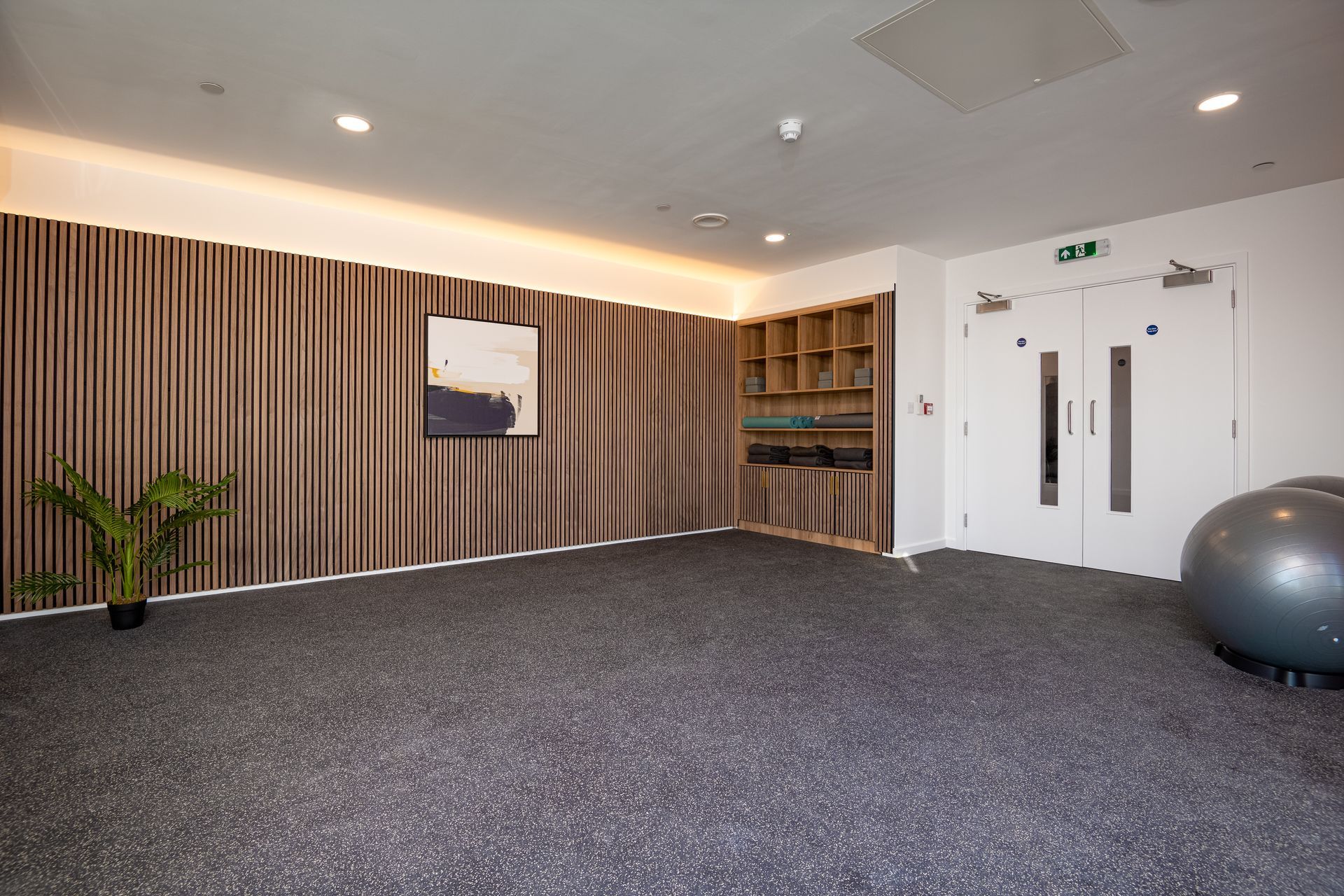 There is a pilates ball in the middle of the room at Walton Court.