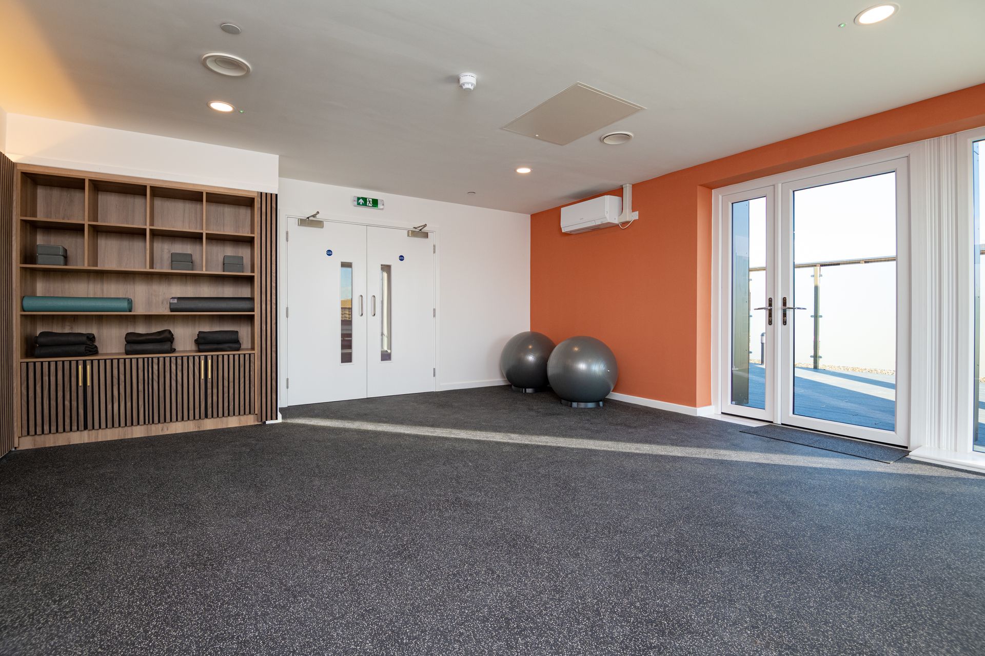 There are two exercise balls in the middle of the room at Walton Court.