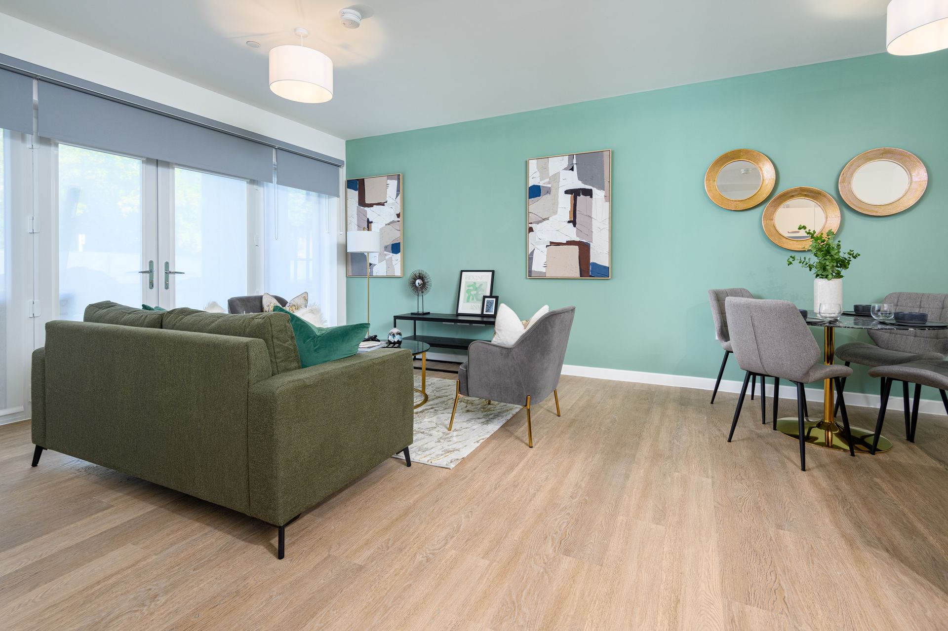 A living room with a green couch , chairs , and a table at Walton Court.