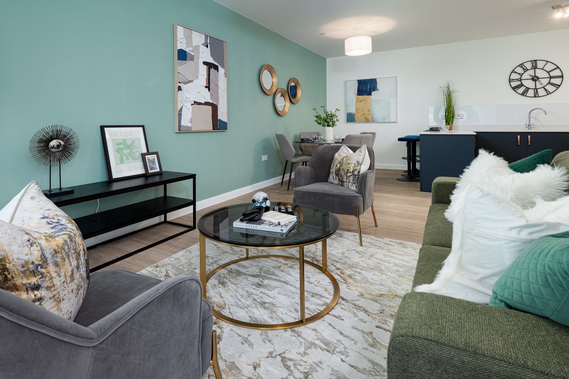 A living room with a couch , chairs , a coffee table and a clock on the wall at Walton Court.