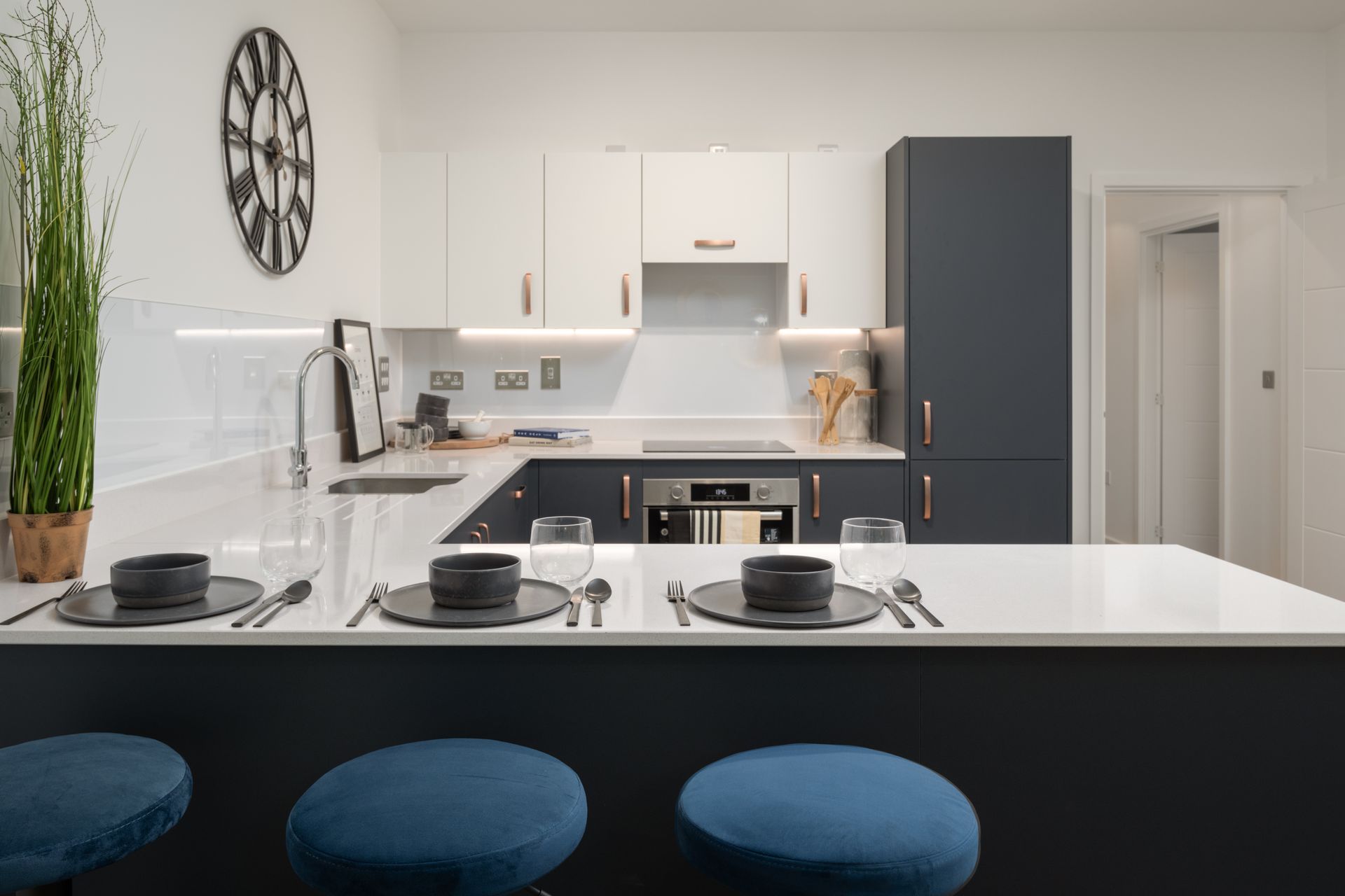 There is a clock on the wall above the kitchen counter at Walton Court.