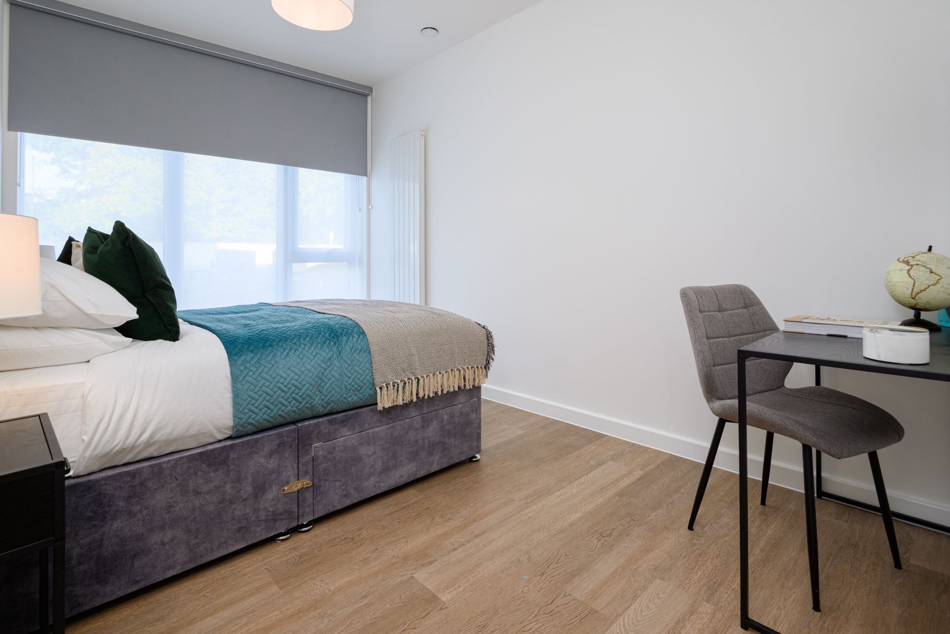 A bedroom with a bed , desk , chair and window at Walton Court.