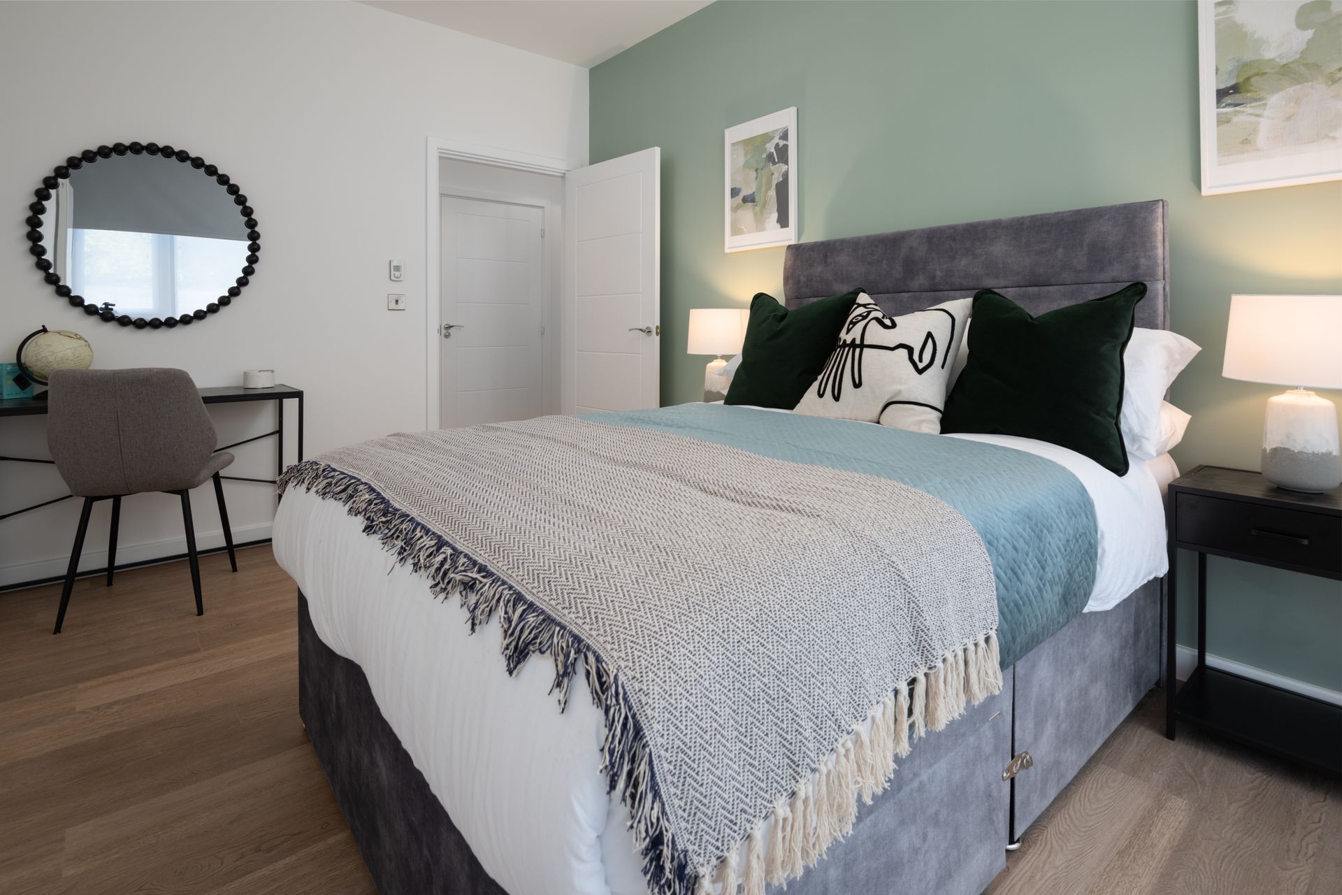 A bedroom with a bed , desk , nightstand and mirror at Walton Court.