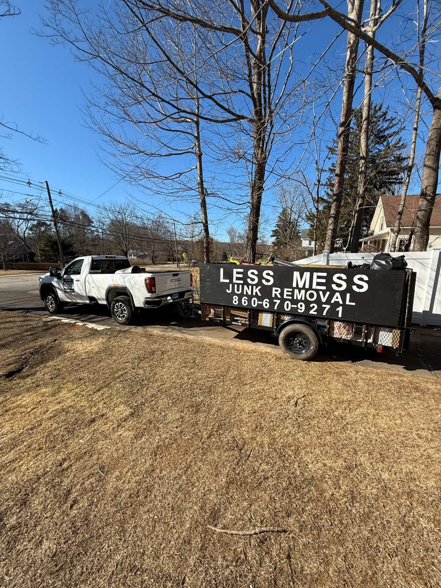 White pickup truck towing a black 