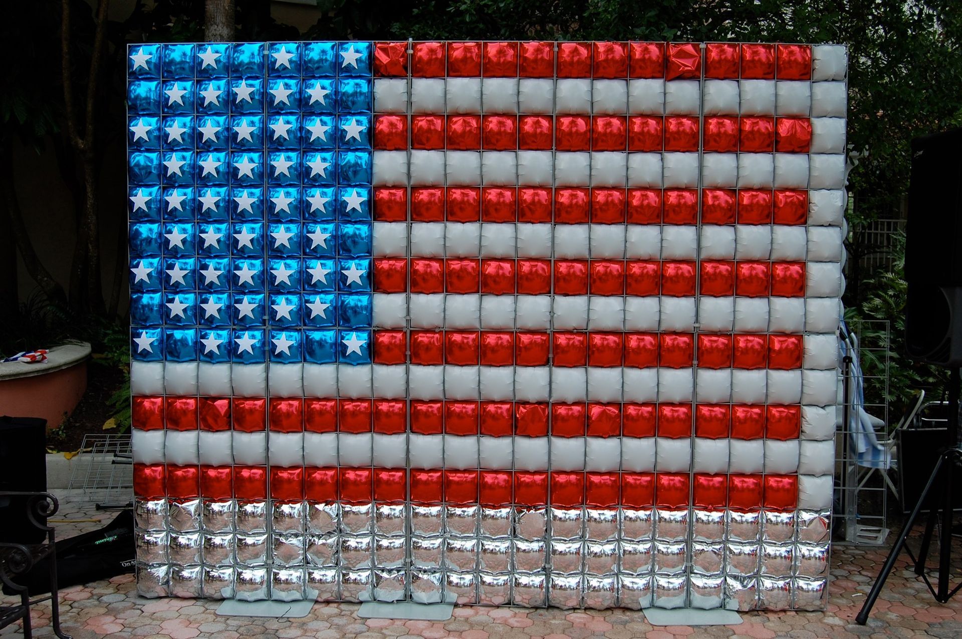 An american flag made out of balloons and cans
