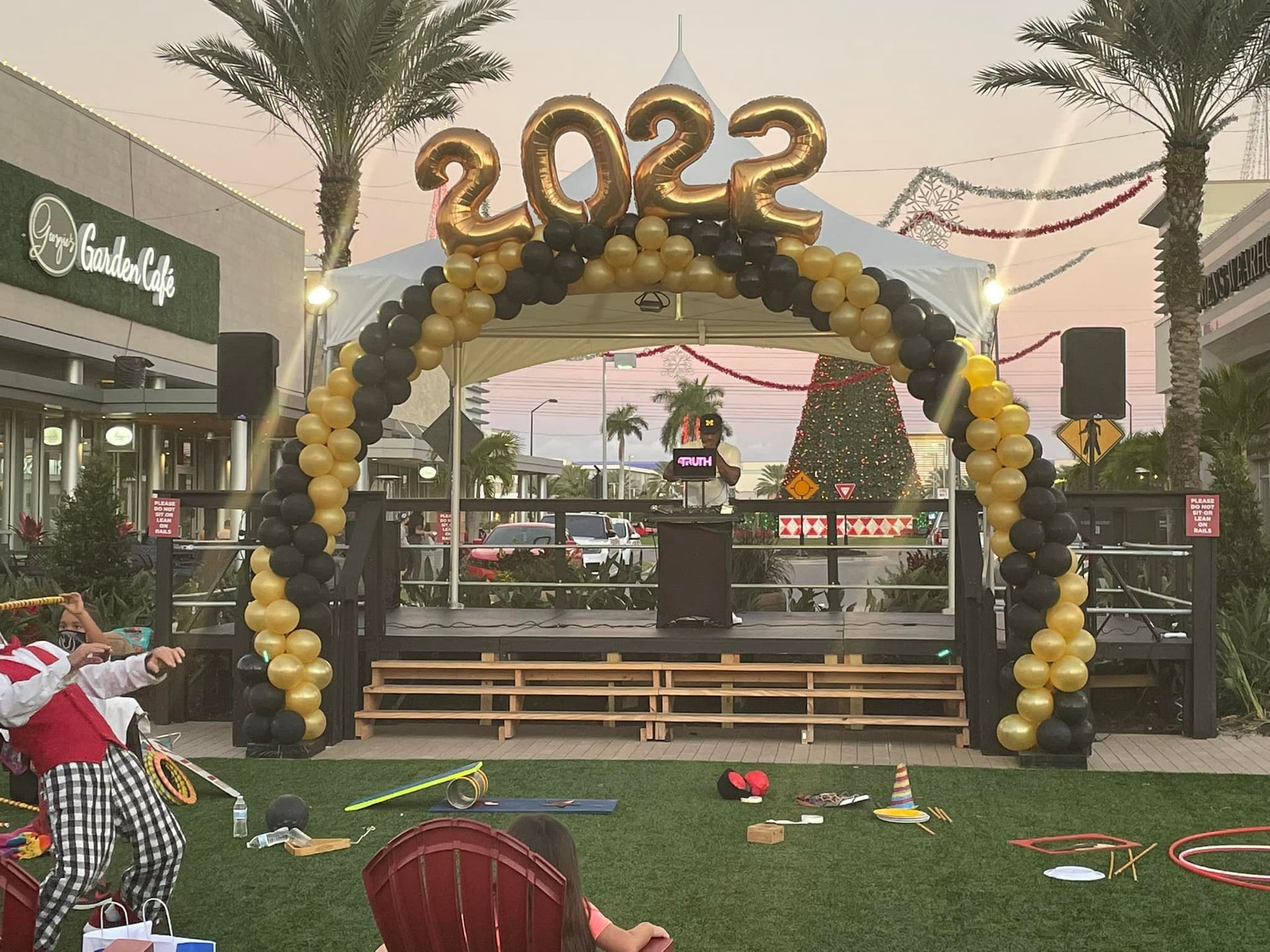 A stage with balloons and a sign that says 2022 on it.