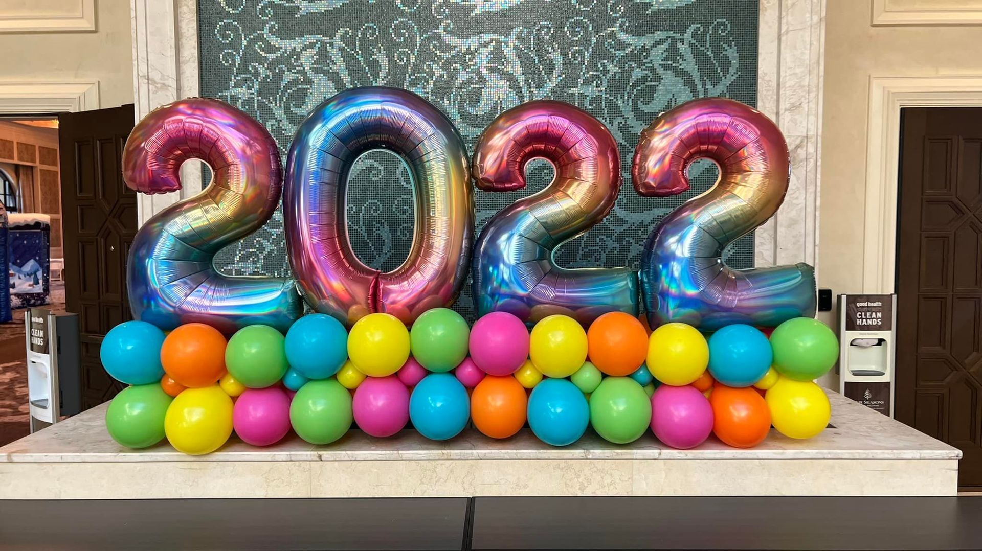 A bunch of colorful balloons are sitting on top of a table.
