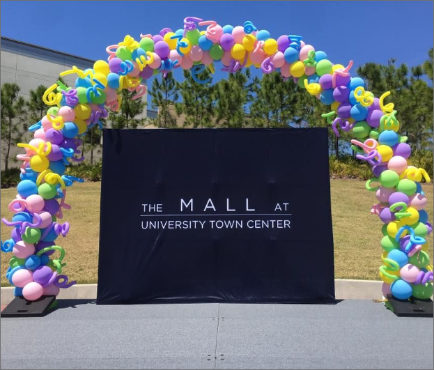 The mall at university town center is decorated with colorful balloons