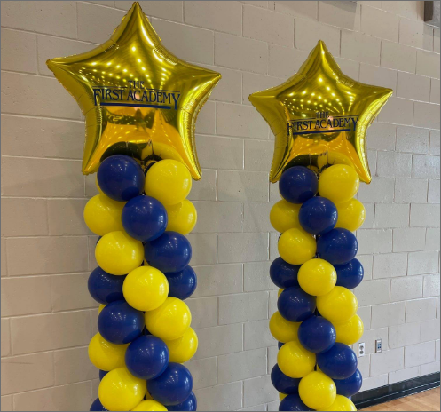 Two columns of yellow and blue balloons with gold stars on them