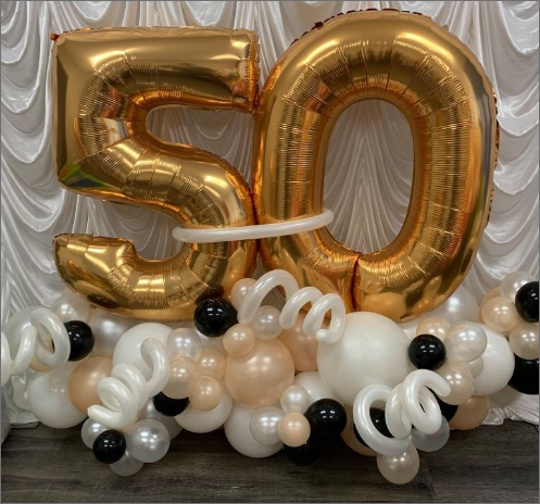 A bunch of balloons with the number 50 on them