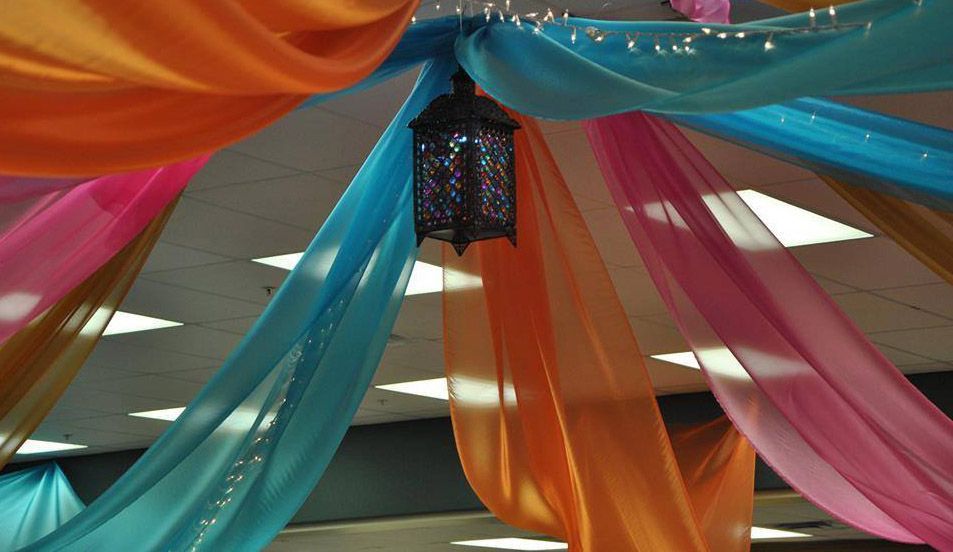 A colorful ceiling with a lantern hanging from it