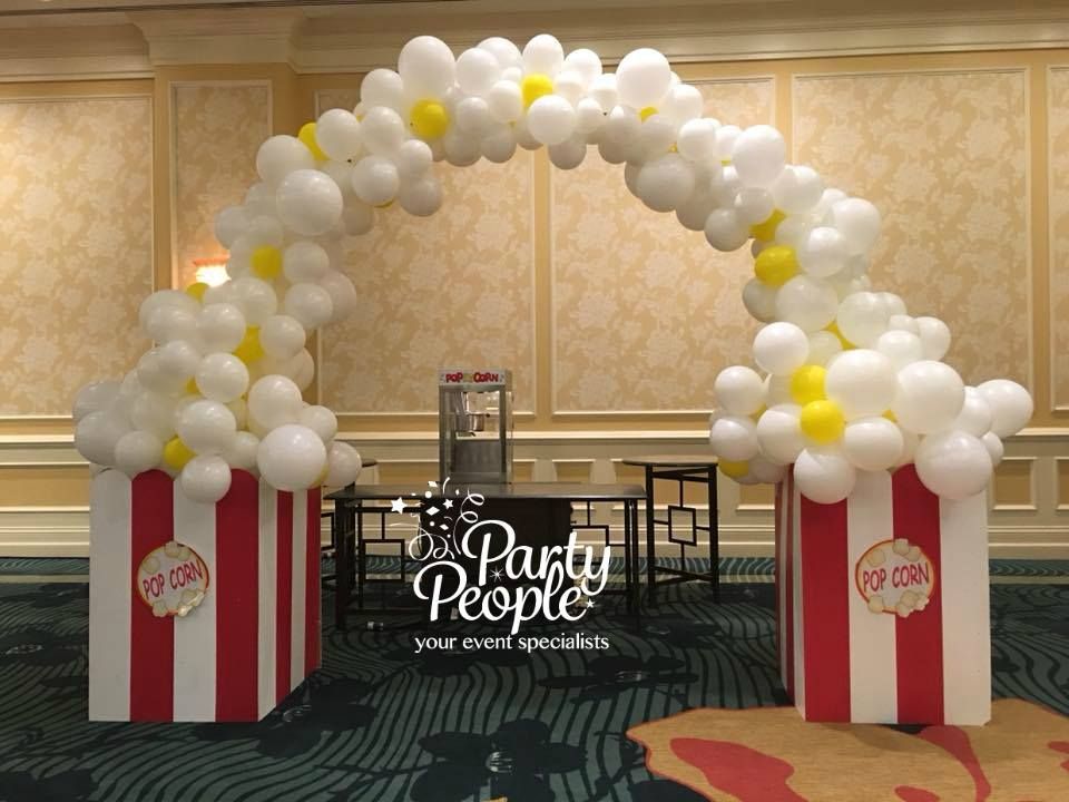 A room decorated with balloons and popcorn boxes