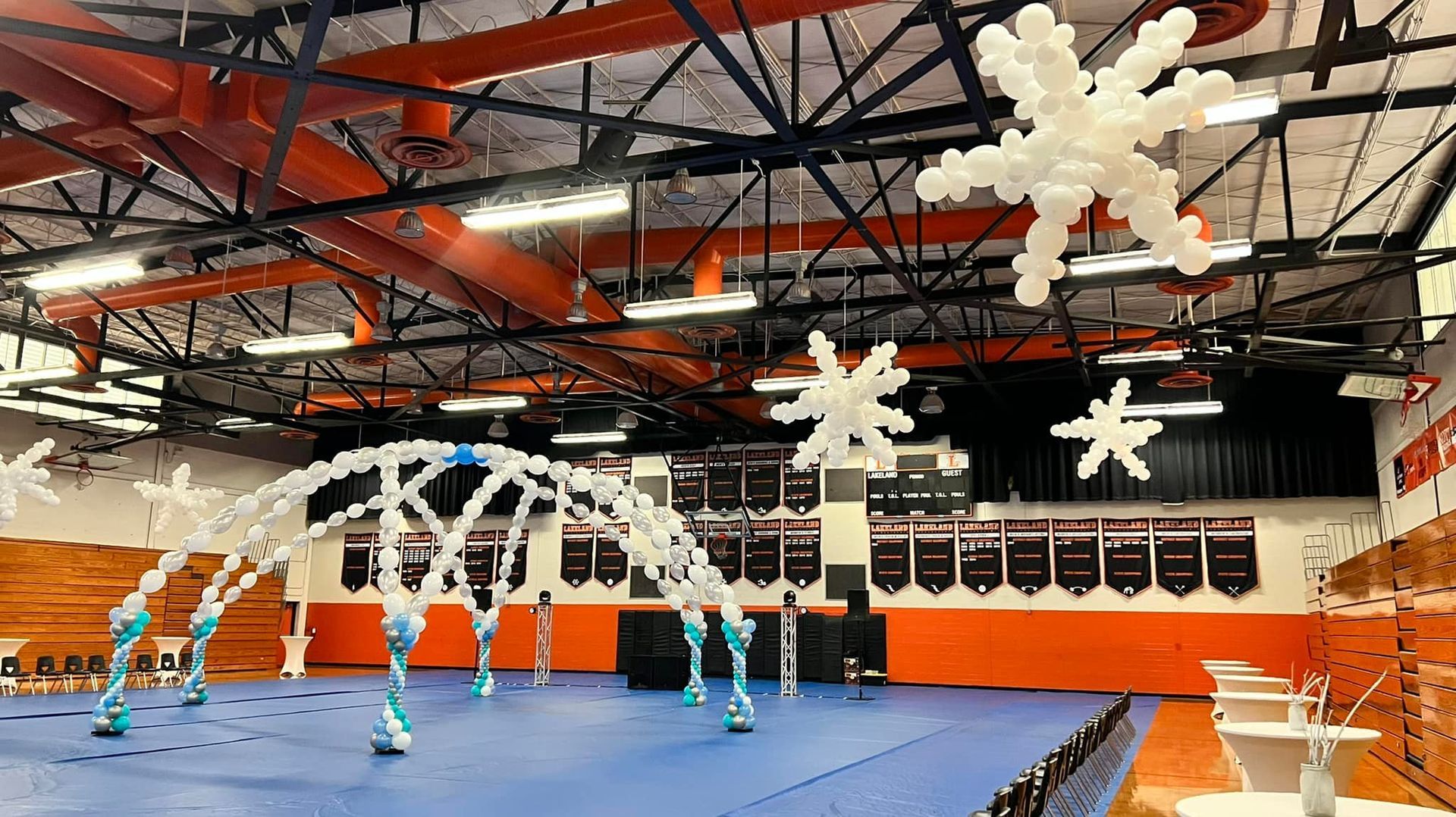 A basketball court decorated with snowflakes and balloons.