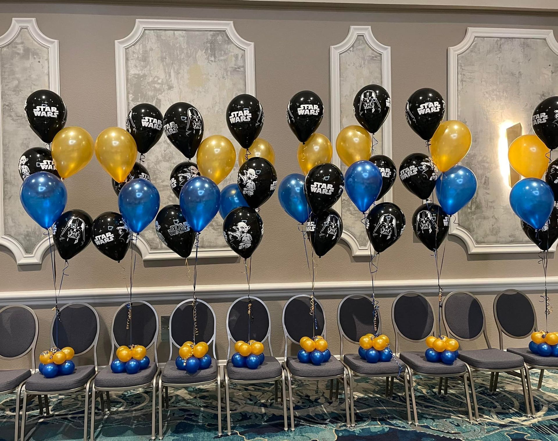 A room filled with lots of balloons and chairs.