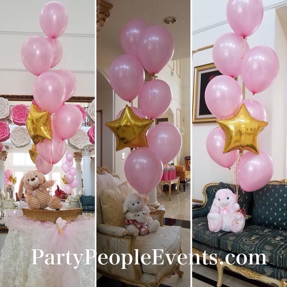 A bunch of pink balloons are sitting on a couch