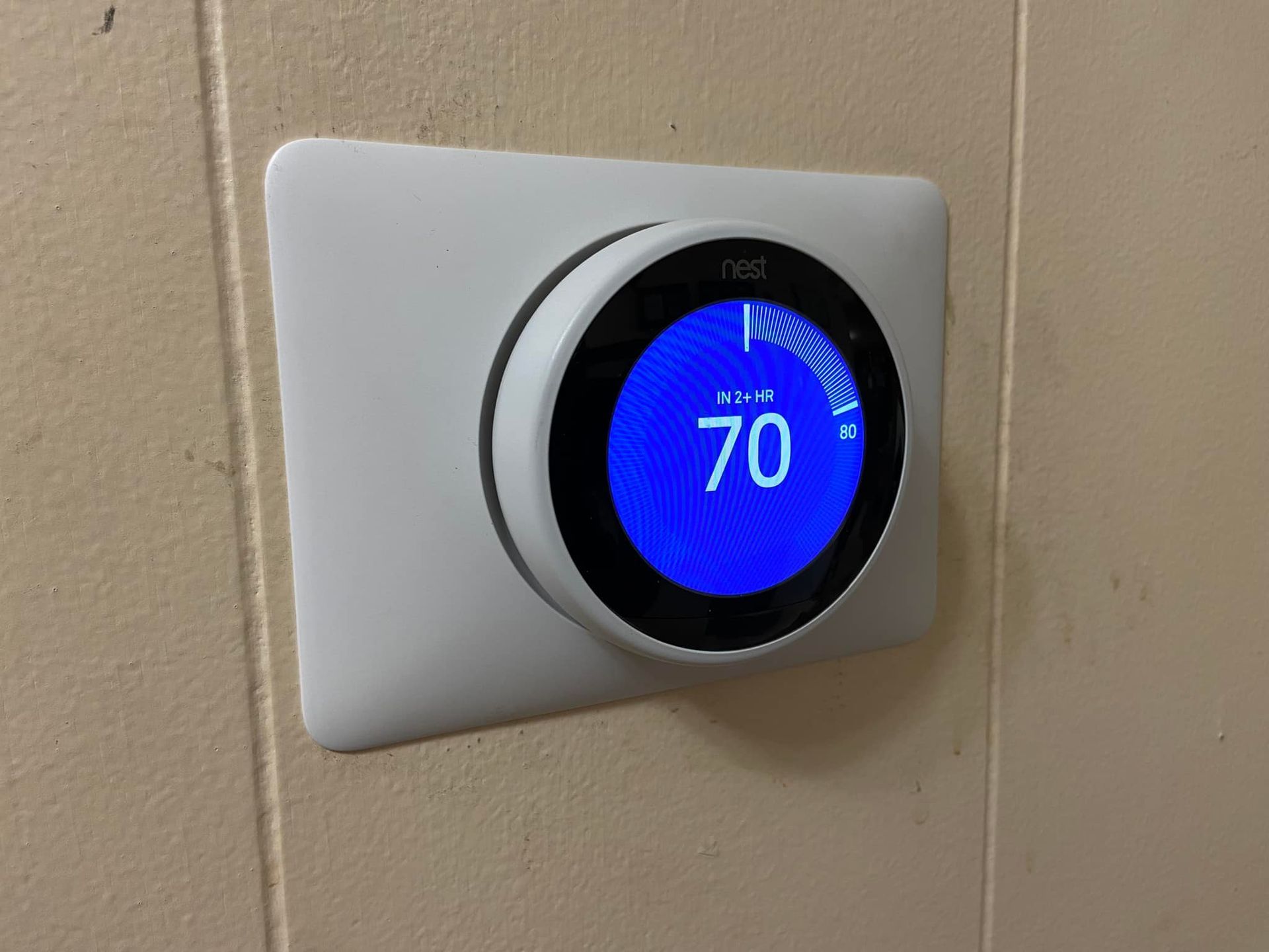 Air Rescue Heating & Cooling | a smart thermostat is mounted on a wall and the temperature is 70 degrees