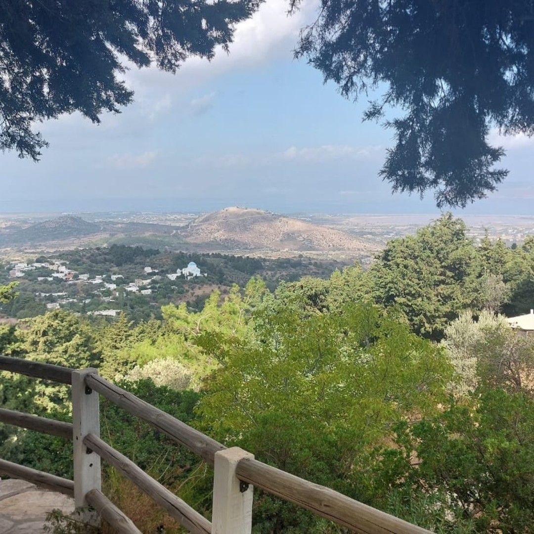 A view of a valley from a wooden fence