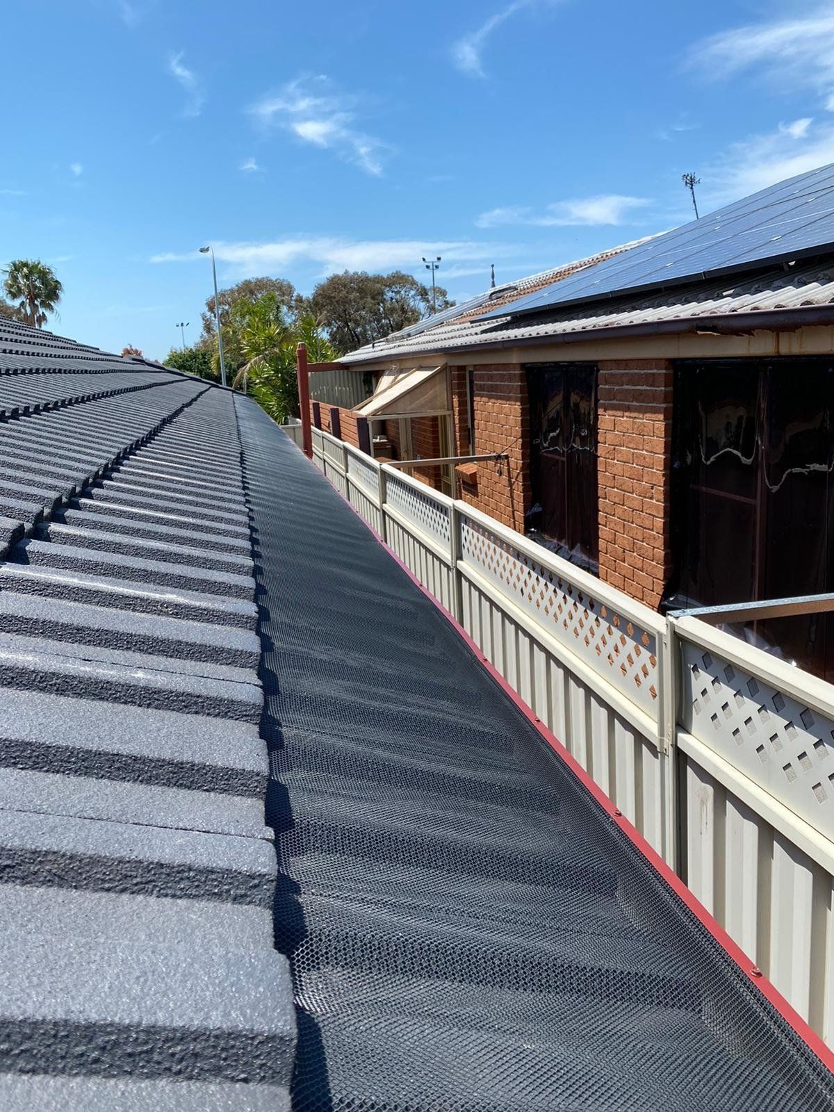 A roof of a house with a walkway leading to it.