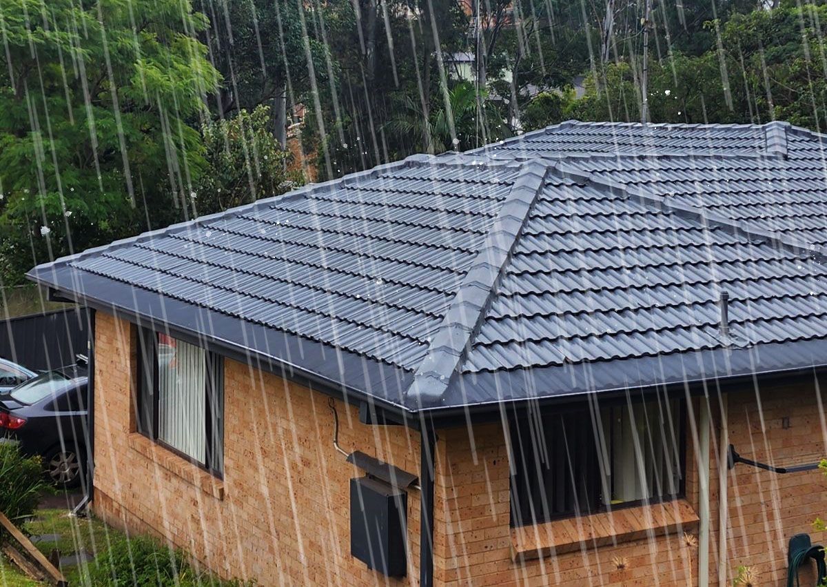 A house with a tiled roof is covered in rain.