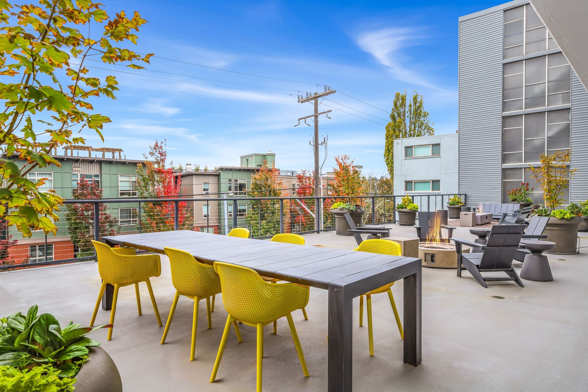 There is a table and chairs on the roof of a building.