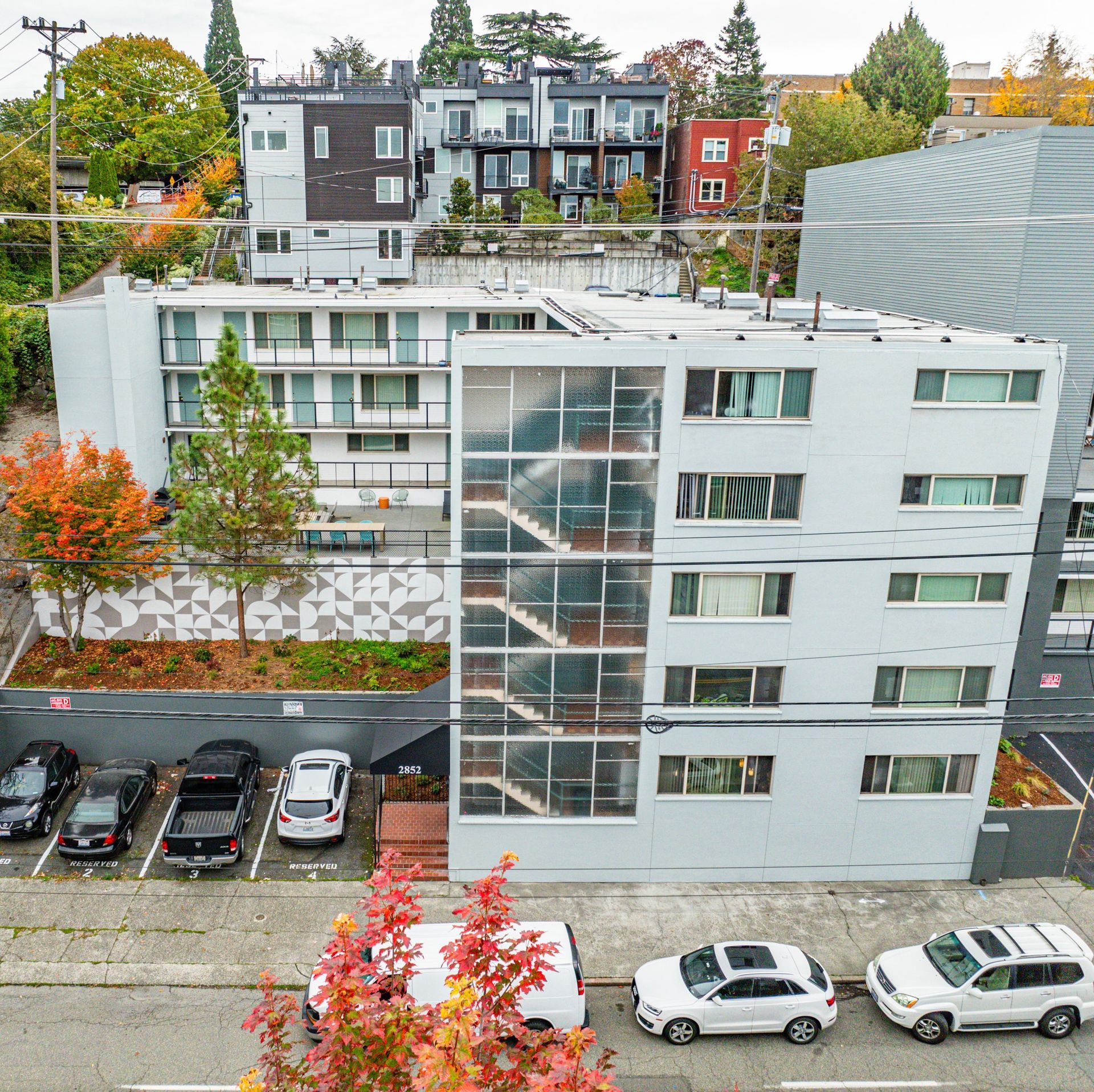 An aerial view of a building with cars parked in front of it