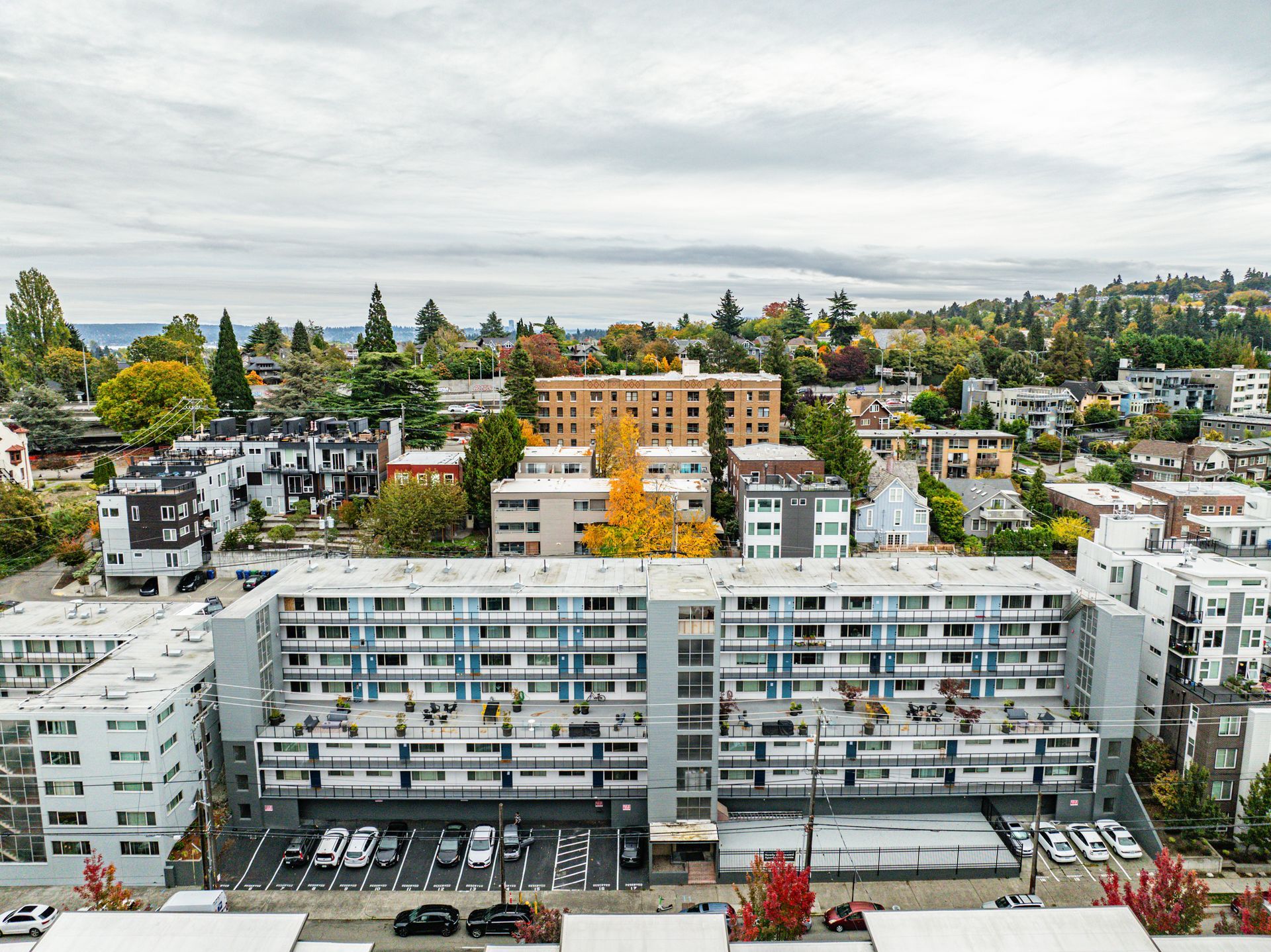 An aerial view of a city with a large building in the middle of it.