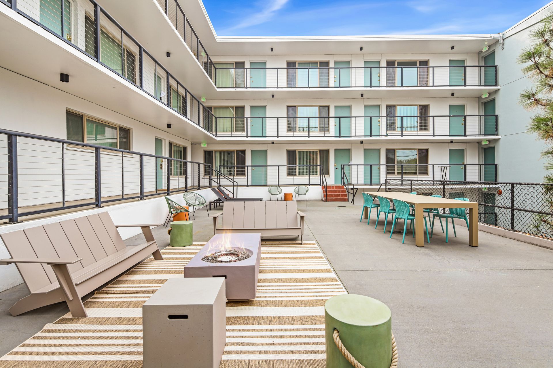 There is a fire pit in the middle of the courtyard of a building.