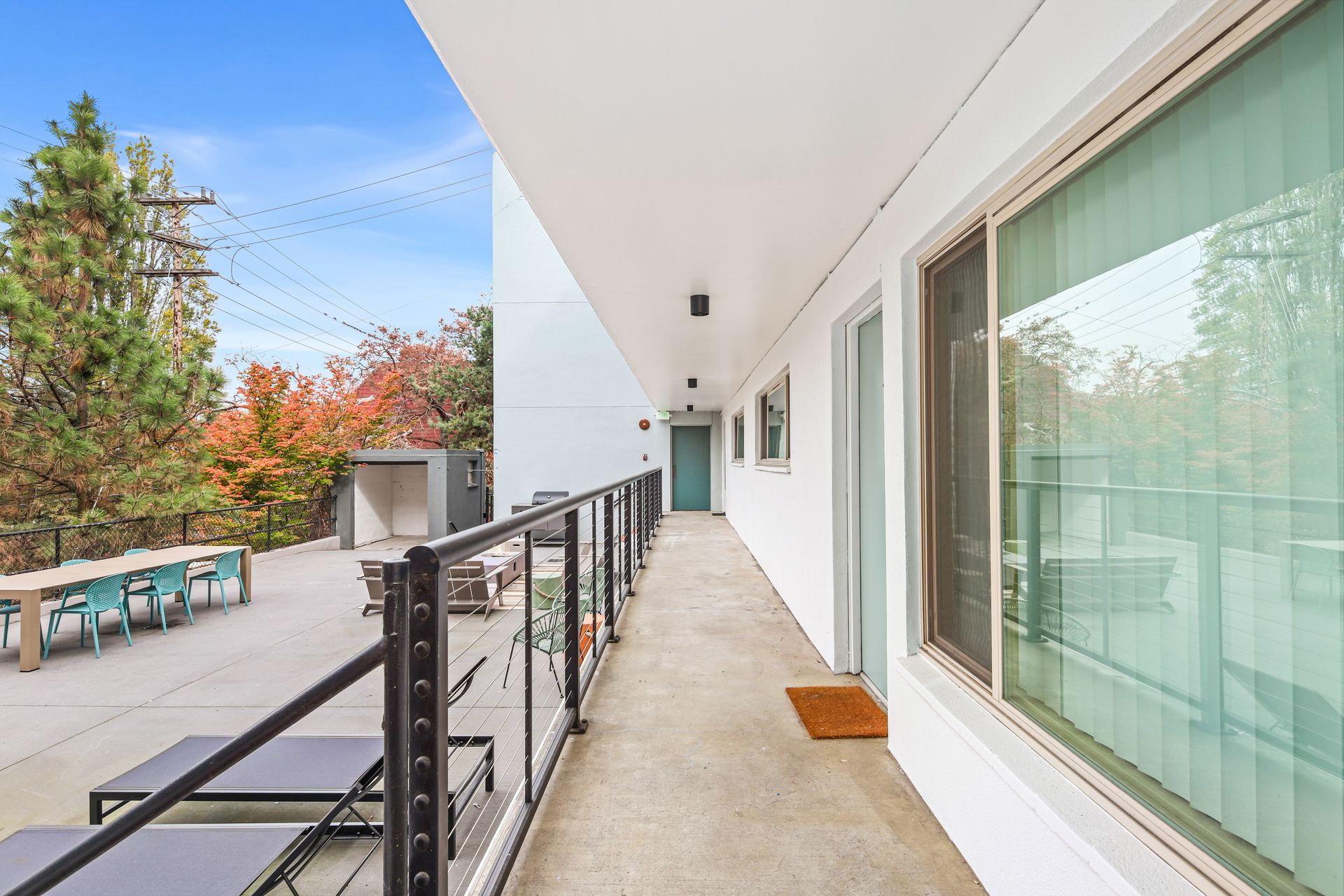 A long hallway between two buildings with a balcony.