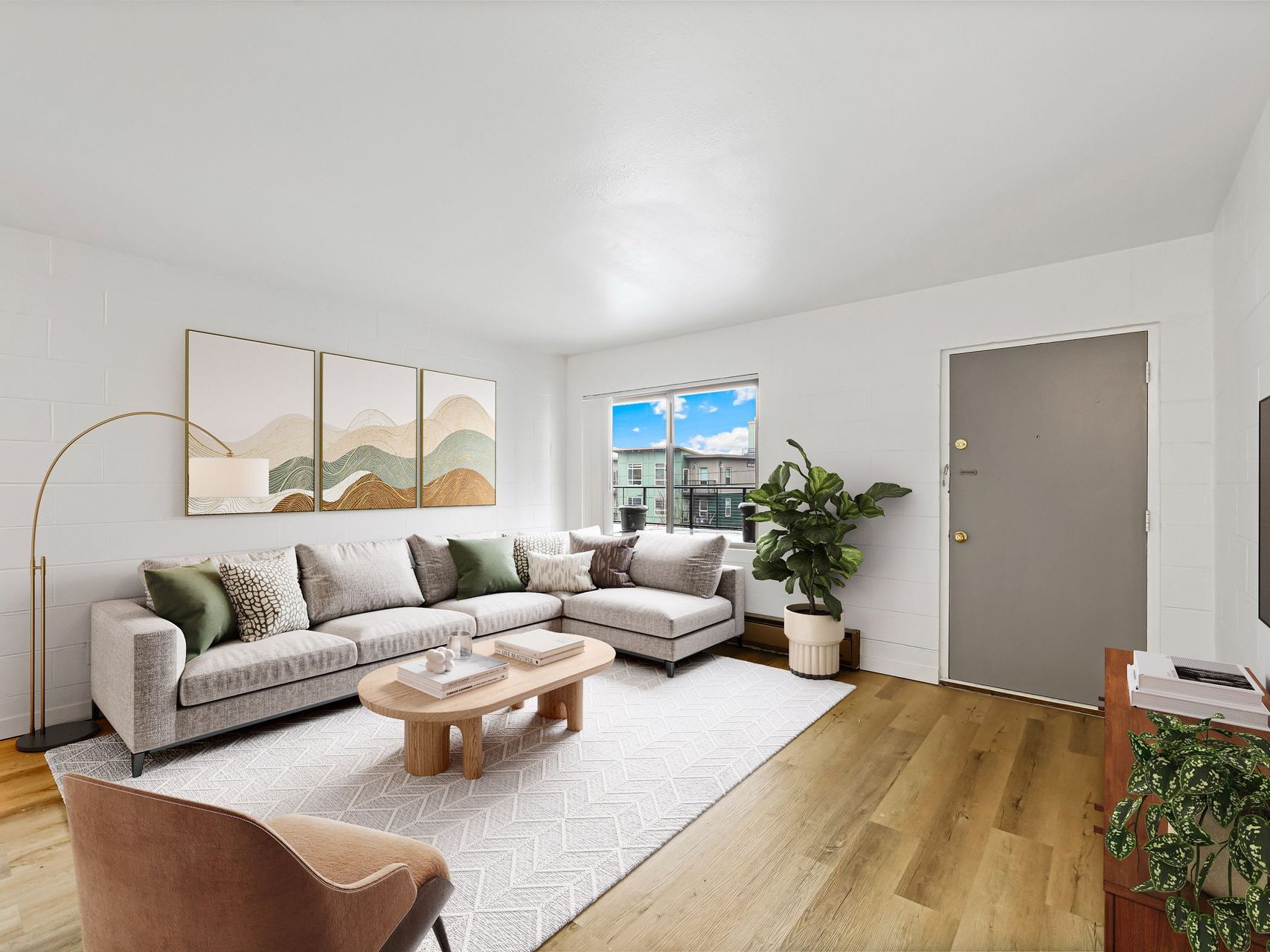 A living room with a large sectional couch and a coffee table.