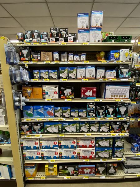 A store shelf full of different types of light bulbs