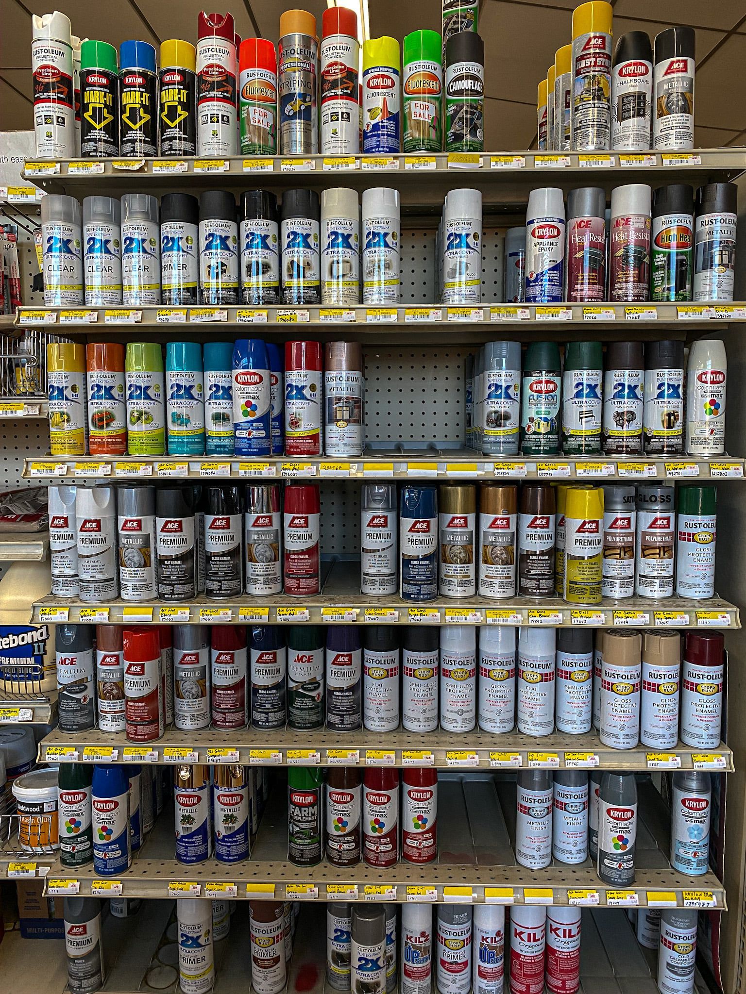 A store shelf filled with a variety of spray paints.