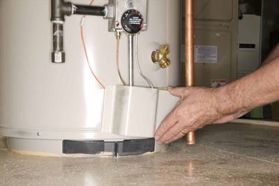 Water Heater Repair — Man Checking Water Heater in San Leandro, CA