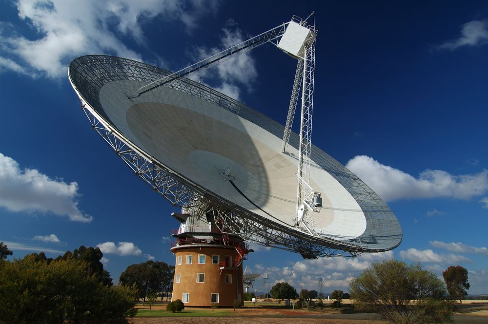 A Large, Silver Radio Telescope Pointed Towards the Sky on a Sunny Day — Pure Plumbing & Electrical in Parkes, NSW