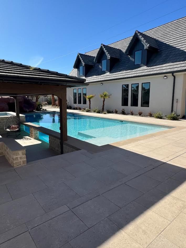 A large house with a large swimming pool in front of it.