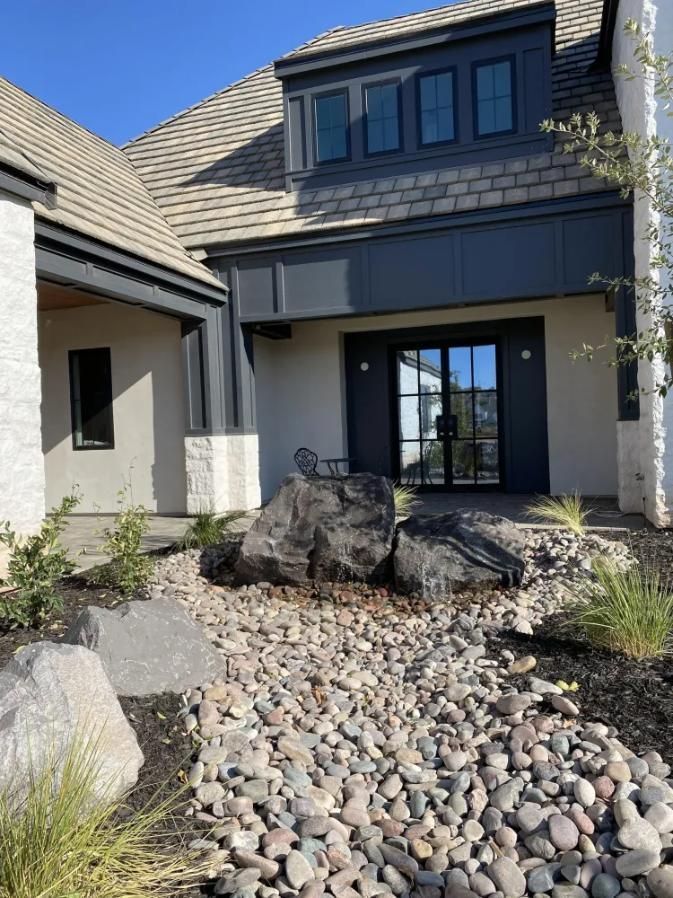 A house with a lot of rocks in front of it