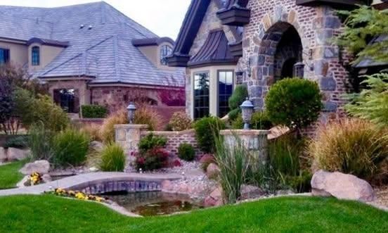A large house with a pond in front of it