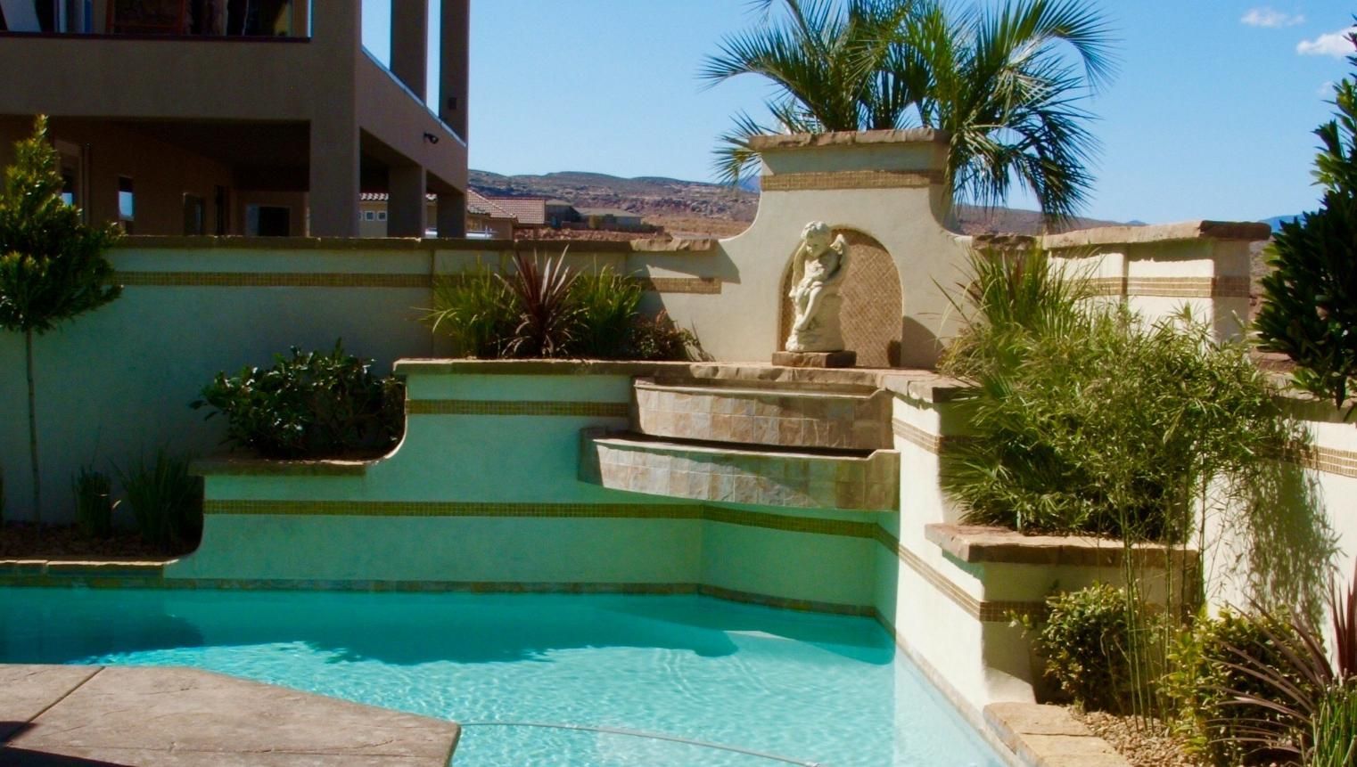 A large swimming pool with a fountain in the middle of it