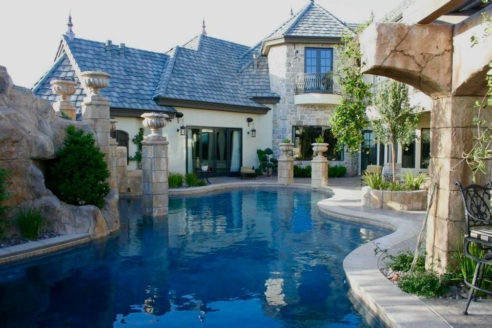 A large house with a large swimming pool in front of it