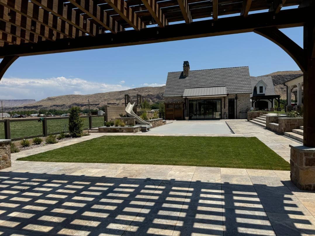 A view of a house from under a pergola.