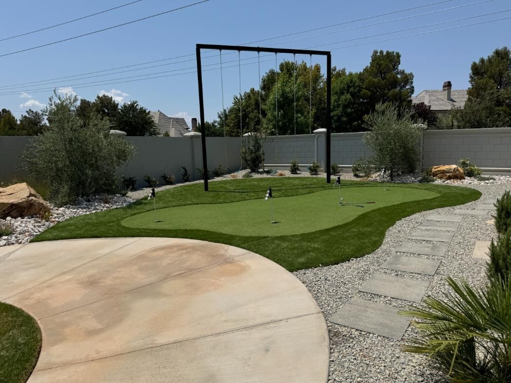 A backyard with a putting green and a swing.