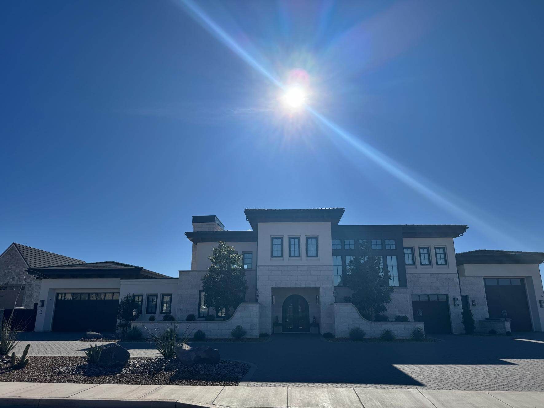 A large house with the sun shining through the windows