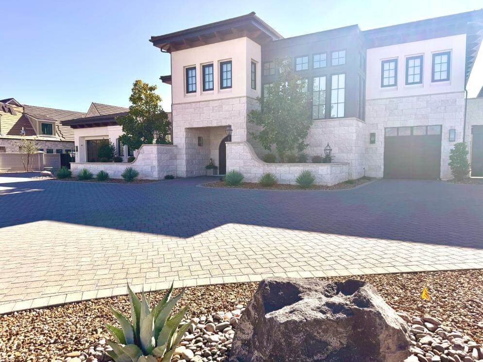 A large house with a lot of windows and a rock in front of it.
