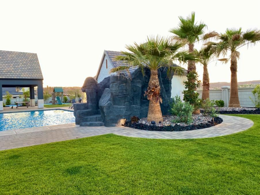 A house with a swimming pool and palm trees in the backyard.